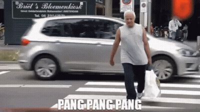 Man Crossing Street In Front Of Briel's Bloemenkiosk GIF