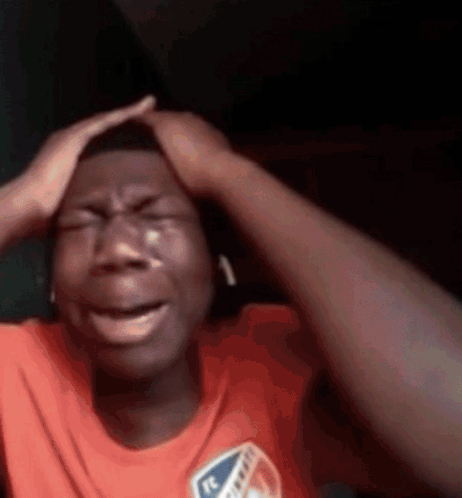 Man Crying And Holding Head While Wearing Headphones GIF