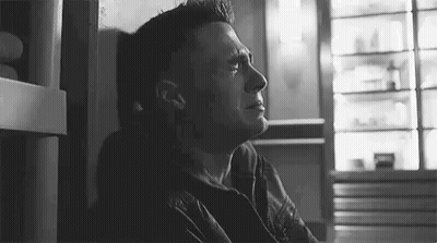 Man Crying In Black And White Photo Beside Wall GIF