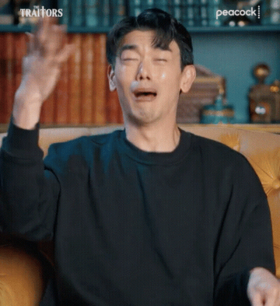 Man Crying On Couch With Hands In Air GIF