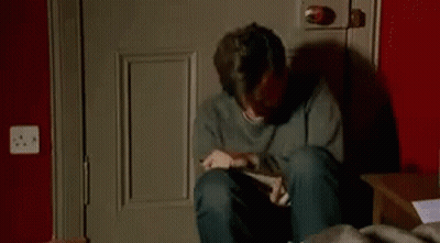 Man Crying On Floor Holding Box GIF