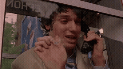 Man Crying On Phone In Front Of Mon93 Sign GIF
