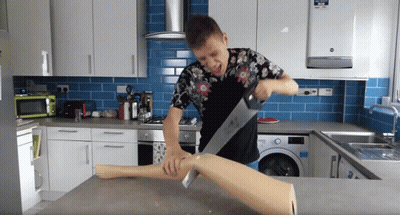 Man Cutting Leg With Saw In Kitchen GIF
