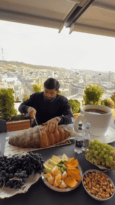 Man Cutting Loaf Of Bread With Knife GIF