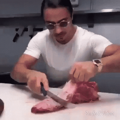 Man Cutting Meat With Knife GIF