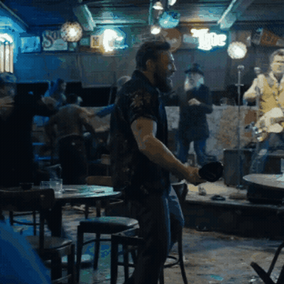 Man Dancing In Bar With The Sign GIF