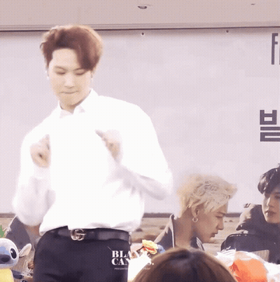 Man Dancing In Front Of Black Cans Sign GIF