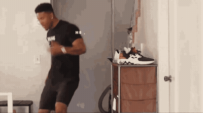 Man Dancing In Front Of Dresser With Shoes GIF