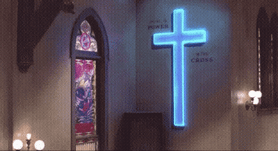 Man Dancing In Front Of Neon Cross Saying We Are A Power GIF