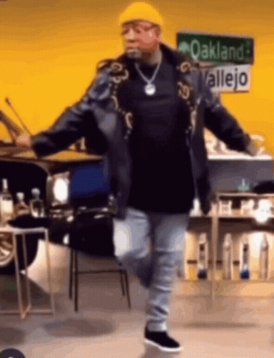 Man Dancing In Front Of Oakland Allejo Sign GIF