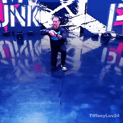 Man Dancing In Front Of Punk Sign GIF