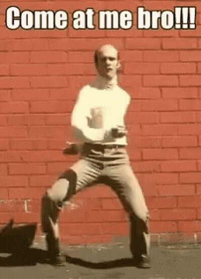 Man Dancing In Front Of Red Brick Wall Saying Come At Me Bro GIF