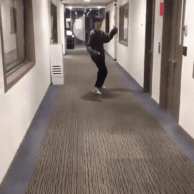 Man Dancing In Hallway With Skateboard GIF