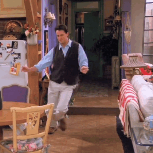 Man Dancing In Living Room In Front Of Refrigerator With Picture Of Man GIF