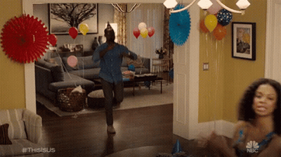 Man Dancing In Living Room With Balloons And Paper Fans GIF