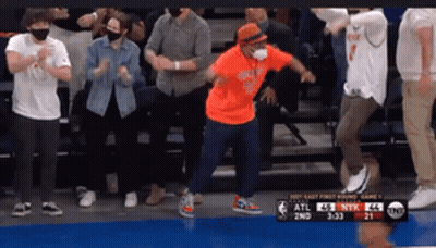 Man Dancing In Orange Shirt Before Crowd GIF