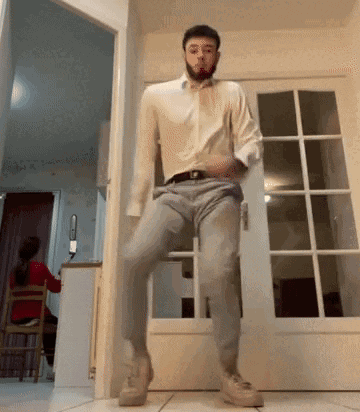 Man Dancing In White Shirt And Grey Pants GIF