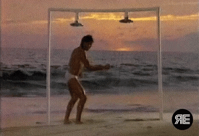 Man Dancing On Beach Under Shower GIF