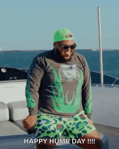 Man Dancing On Boat In Green Hat And Shorts GIF