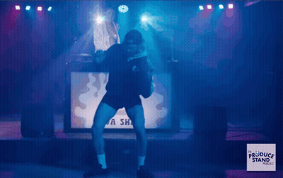 Man Dancing On Stage In Front Of A Sha Sign GIF