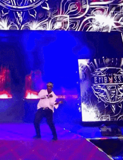 Man Dancing On Stage In Front Of Embassy Screen GIF