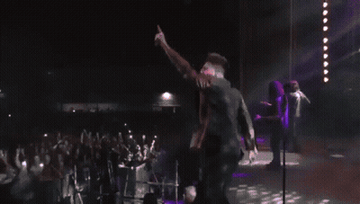 Man Dancing On Stage In Front Of Neon A GIF
