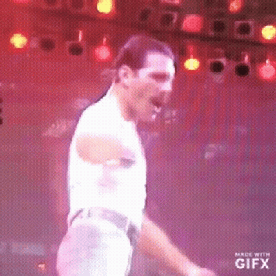 Man Dancing On Stage In Front Of Red Lights GIF