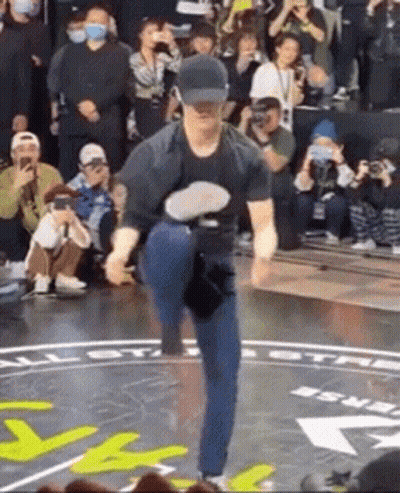 Man Dancing On Stage In Hat Before Crowd GIF