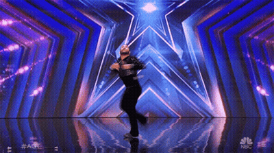 Man Dancing On Stage With NBC Logo GIF