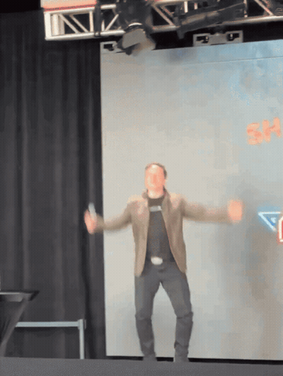 Man Dancing On Stage With Sign Saying Sh GIF