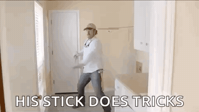 Man Dancing With His Stick Does Tricks GIF