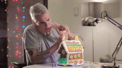 Man Decorating Gingerbread House GIF