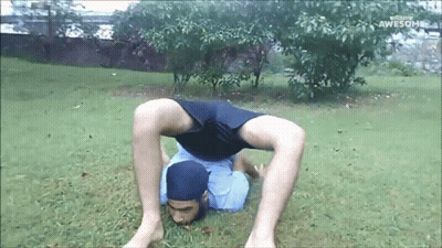 Man Doing Handstand In Grass Saying Awesome GIF