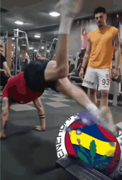 Man Doing Handstand While Man In 93 Shorts Watches GIF