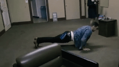 Man Doing Push Ups While Woman Looks On GIF