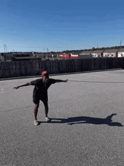 Man Doing Skateboard Trick On Road GIF