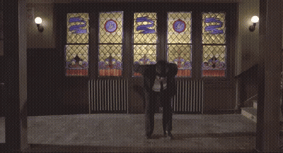 Man Doing Trick In Front Of Stained Glass Window With Letter G GIF
