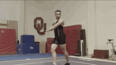 Man Doing Trick On Gym Floor With Letter Q GIF