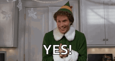 Man Dressed As Christmas Elf Smiling Saying Yes In Kitchen GIF