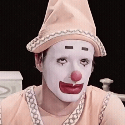Man Dressed As Clown With Red Nose And White Face Paint GIF