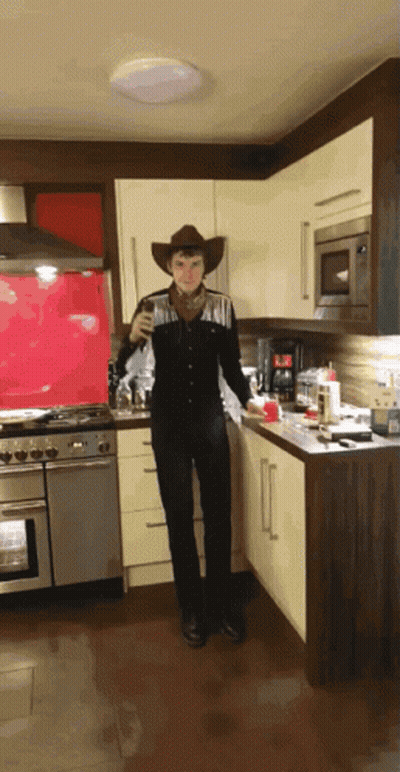 Man Dressed As Cowboy In Kitchen GIF