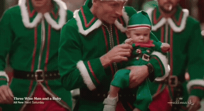 Man Dressed As Elf Holding Baby GIF
