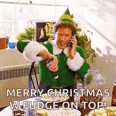 Man Dressed As Elf Talking On Phone Pouring Fudge On Popcorn GIF