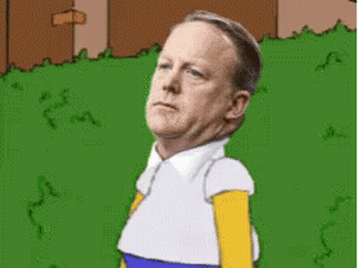 Man Dressed As Homer Simpson Standing In Grass GIF