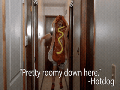 Man Dressed As Hotdog Walking Down Hallway GIF