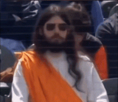 Man Dressed As Jesus In Sunglasses And Orange Robe GIF