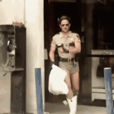 Man Dressed As Police Officer Holding Bag GIF