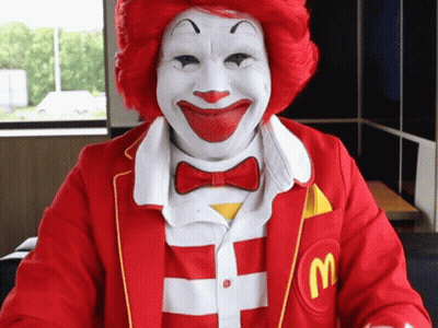 Man Dressed As Ronald McDonald With Red Hair And White Face Paint GIF