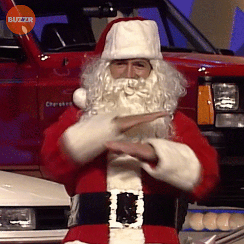 Man Dressed As Santa Claus In Front Of Red Cherokee Truck GIF
