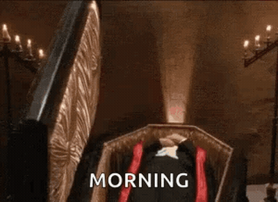 Man Dressed As Vampire Adjusting Mask GIF